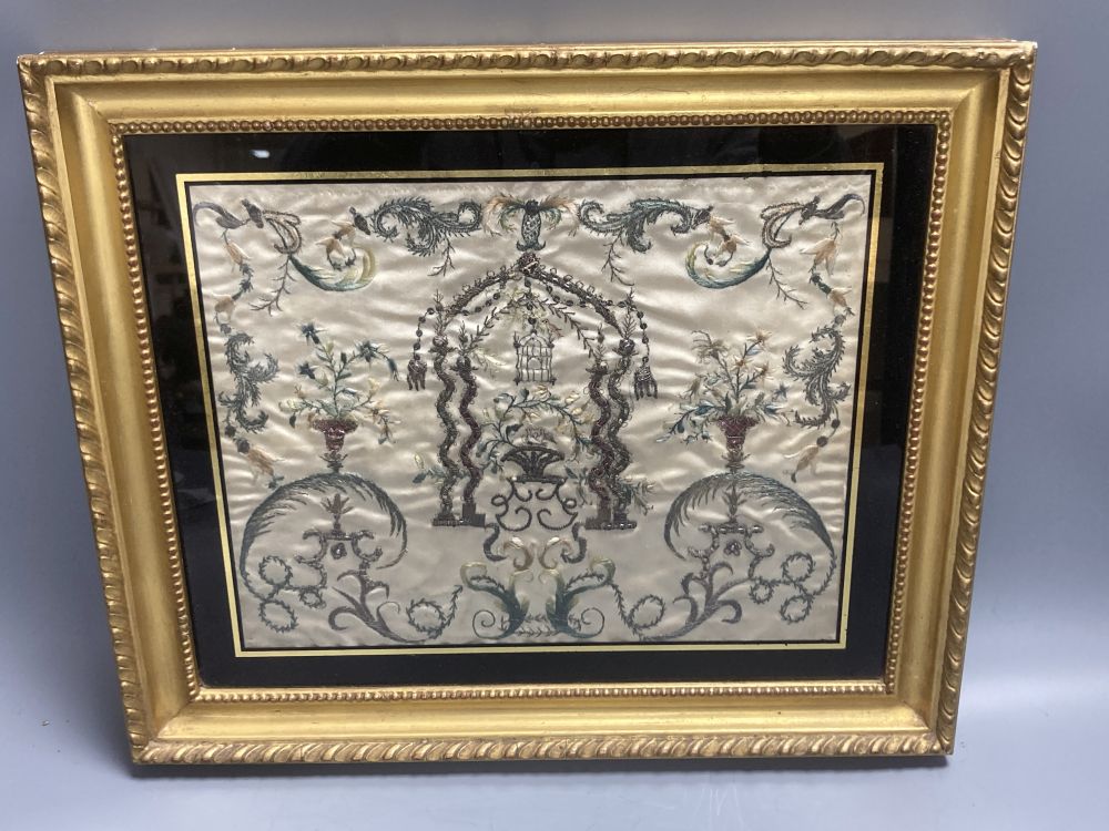 A Regency silk panel, embroidered with a bird cage and scrolling flowers and foliage, framed, 29 x 35cm